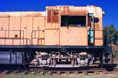 275-33
Port Hedland, Don Rhodes Mining Museum, preserved Goldsworthy Mining B class unit #2 serial number A-105, these units of Bo-Bo design with a 6CSRKT 640 kW prime mover were built at the English Electric Rocklea Qld plant in 1965 and primarily used for the construction of the Goldsworthy to Finucane Island railway, then ore trains and then the daily supply train once the A class arrived. August 10, 2003.
Keywords: 2;B-class;English-Electric-Qld;ST95B;A-105;GML;Goldsworthy-Mining;