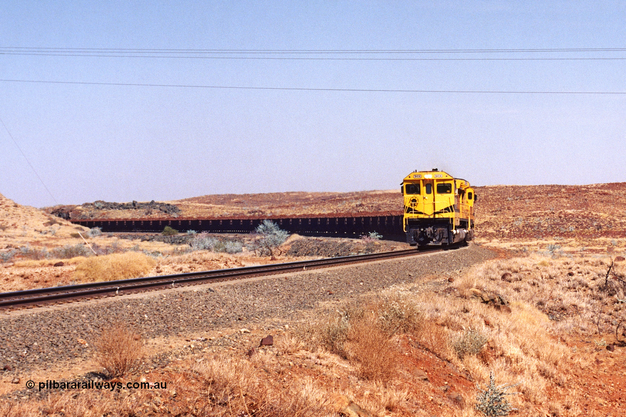 283-14
At the 45.4 km grade crossing on the Robe River line, loaded train easers around the curve behind the standard quad Goninan CM40-8M units led by 9414 serial number 8206-11 / 91-124 and rebuilt from the final of the original five ALCo units ordered from construction. 22nd of May 2002.
Keywords: 9414;Goninan;GE;CM40-8M;8206-11/91-124;rebuild;AE-Goodwin;ALCo;M636;G6060-5;