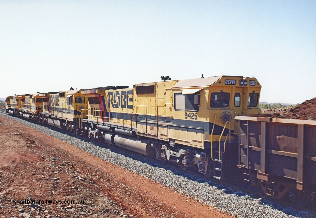 283-26
Harding Siding, Robe River locomotive 9425 which is a Goninan WA ALCo to GE rebuild CM40-8M with serial 6266-8 / 89-85 from August 1989 riding on Hi-Ad bogies and was originally an AE Goodwin built M636 ALCo serial C-6041-4 and built new for Mt Newman Mining (later BHP Iron Ore) in April 1970 and numbered 5468, sold to Robe and delivered by road 17th August 1982. Everything below the frame is ALCo while above is GE and Pilbara Cab.
Keywords: 9425;Goninan;GE;CM40-8M;6266-8/89-85;rebuild;AE-Goodwin;ALCo;M636;G-6041-4;