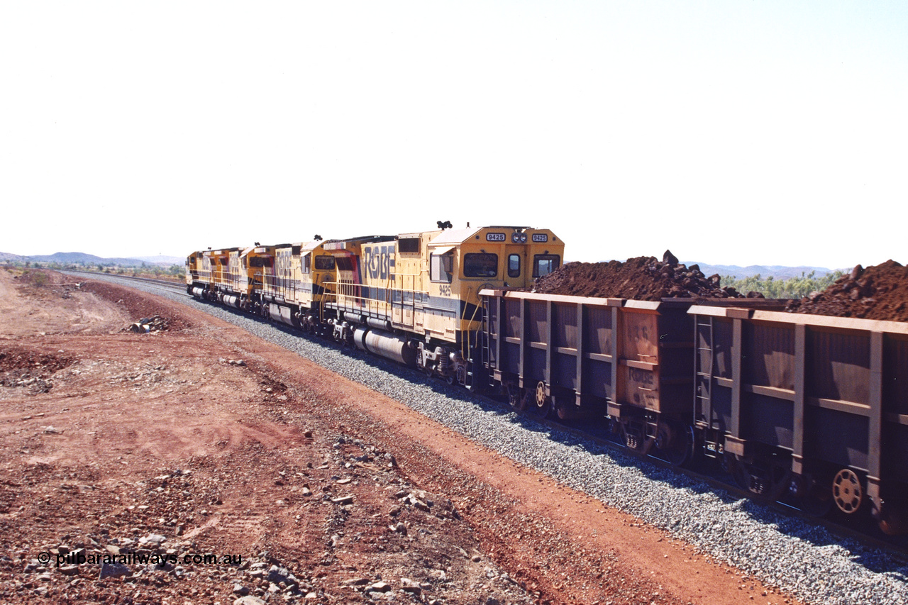 283-27
Harding Siding, quad Robe River CM40-8M units 9414, 9420, 9410 and 9425 lead their 202 loaded ore waggons through the passing track at Siding 1 (Harding) following recent extension of the loop and renaming to Harding. The extension is at the north end to accommodate the new West Angelas trains of up to 240 waggons. Wednesday 22nd May 2002.
Keywords: 9425;Goninan;GE;CM40-8M;6266-8/89-85;rebuild;AE-Goodwin;ALCo;M636;G-6041-4;