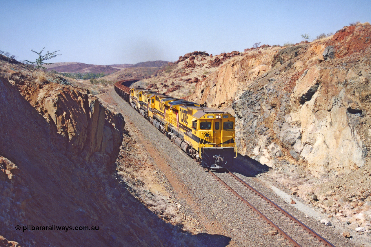 283-32
Near Woodbrook as quad Robe River CM40-8M units 9414, 9420, 9410 and 9525 work a loaded 202 waggons bound for Cape Lambert as they power through the cutting up a short grade at the 37.5 km pipe bridge. 9414 with serial number 8206-11 / 91-124 was rebuilt by Goninan in 1991 from AE Goodwin built M636 ALCo model with original serial number G-6060-5 from 1971. 22nd of May 2002.
Keywords: 9414;Goninan;GE;CM40-8M;8206-11/91-124;rebuild;AE-Goodwin;ALCo;M636;G6060-5;