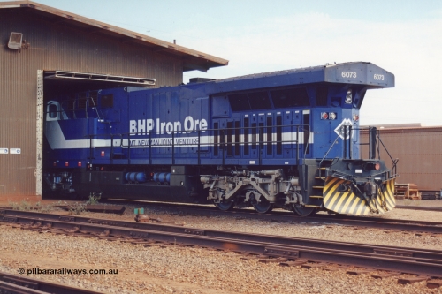 283-02
Nelson Point, BHP wheel lathe sees BHP's big GE AC6000 unit 6073 'Fortescue' serial number 51065 on shed having wheel attention to the leading bogie. May 2002.
Keywords: 6073;GE;AC6000CW;51065;