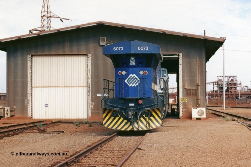 283-03
Nelson Point, BHP wheel lathe sees BHP's big GE AC6000 unit 6073 'Fortescue' serial number 51065 on shed having wheel attention to the leading bogie. May 2002.
Keywords: 6073;GE;AC6000CW;51065;