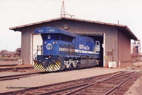 283-04
Nelson Point, BHP wheel lathe sees BHP's big GE AC6000 unit 6073 'Fortescue' serial number 51065 on shed having wheel attention to the leading bogie. May 2002.
Keywords: 6073;GE;AC6000CW;51065;