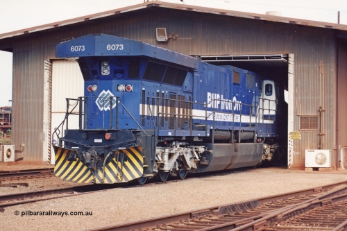 283-05
Nelson Point, BHP wheel lathe sees BHP's big GE AC6000 unit 6073 'Fortescue' serial number 51065 on shed having wheel attention to the leading bogie. May 2002.
Keywords: 6073;GE;AC6000CW;51065;