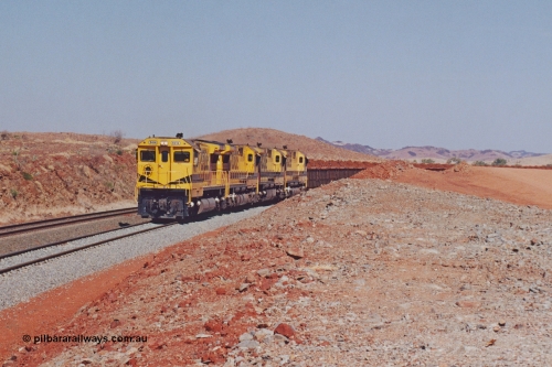 283-18
Harding Siding, quad Robe River CM40-8M units 9414, 9420, 9410 and 9425 lead 202 loaded ore waggons at Siding 1 (Harding). The siding has recently been renamed Harding and extended at the north end to accommodate the new West Angelas trains of up to 240 waggons. Wednesday 22nd May 2002.
Keywords: 9414;Goninan;GE;CM40-8M;8206-11/91-124;rebuild;AE-Goodwin;ALCo;M636;G6060-5;