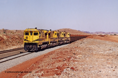 283-19
Harding Siding, quad Robe River CM40-8M units 9414, 9420, 9410 and 9425 lead 202 loaded ore waggons at Siding 1 (Harding). The siding has recently been renamed Harding and extended at the north end to accommodate the new West Angelas trains of up to 240 waggons. Wednesday 22nd May 2002.
Keywords: 9414;Goninan;GE;CM40-8M;8206-11/91-124;rebuild;AE-Goodwin;ALCo;M636;G6060-5;