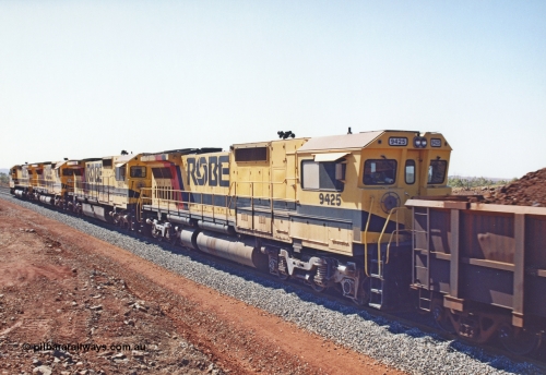 283-26
Harding Siding, Robe River locomotive 9425 which is a Goninan WA ALCo to GE rebuild CM40-8M with serial 6266-8 / 89-85 from August 1989 riding on Hi-Ad bogies and was originally an AE Goodwin built M636 ALCo serial C-6041-4 and built new for Mt Newman Mining (later BHP Iron Ore) in April 1970 and numbered 5468, sold to Robe and delivered by road 17th August 1982. Everything below the frame is ALCo while above is GE and Pilbara Cab.
Keywords: 9425;Goninan;GE;CM40-8M;6266-8/89-85;rebuild;AE-Goodwin;ALCo;M636;G-6041-4;