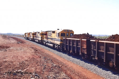 283-27
Harding Siding, quad Robe River CM40-8M units 9414, 9420, 9410 and 9425 lead their 202 loaded ore waggons through the passing track at Siding 1 (Harding) following recent extension of the loop and renaming to Harding. The extension is at the north end to accommodate the new West Angelas trains of up to 240 waggons. Wednesday 22nd May 2002.
Keywords: 9425;Goninan;GE;CM40-8M;6266-8/89-85;rebuild;AE-Goodwin;ALCo;M636;G-6041-4;