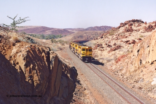 283-30
Near Woodbrook as quad Robe River CM40-8M units 9414, 9420, 9410 and 9525 work a loaded 202 waggons bound for Cape Lambert as they power through the cutting up a short grade at the 37.5 km pipe bridge. 9414 with serial number 8206-11 / 91-124 was rebuilt by Goninan in 1991 from AE Goodwin built M636 ALCo model with original serial number G-6060-5 from 1971. May 22, 2002.
Keywords: 9414;Goninan;GE;CM40-8M;8206-11/91-124;rebuild;AE-Goodwin;ALCo;M636;G6060-5;