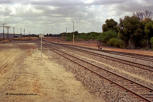 284-13
Narngulu yard looking south east across the grade crossing for Rudds Gully Road with the line to Mullewa curving away to the left and the line to Dongara curving away to the right. November 9, 2004.
