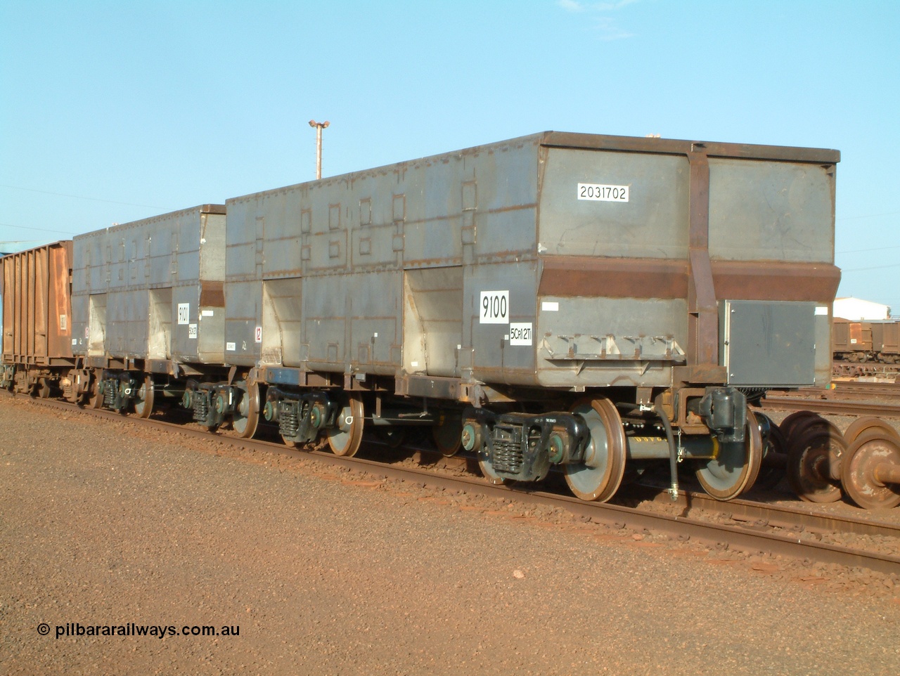 041225 064557
Nelson Point Ore Car Repair Shops, brand new Bradken NSW built ore waggon and type leader 9100 asset number 2031702 and 9101 behind it. These waggons are the latest additions to the fleet with 20 on order in total. They are made from the same 5Cr12Ti steel that the Goninan Golynx waggons are made. 9100 has been set up for use as a 'test' waggon with load sensors located all over it. 25th December 2004.
Keywords: 9100;Bradken-NSW;BHP-ore-waggon;