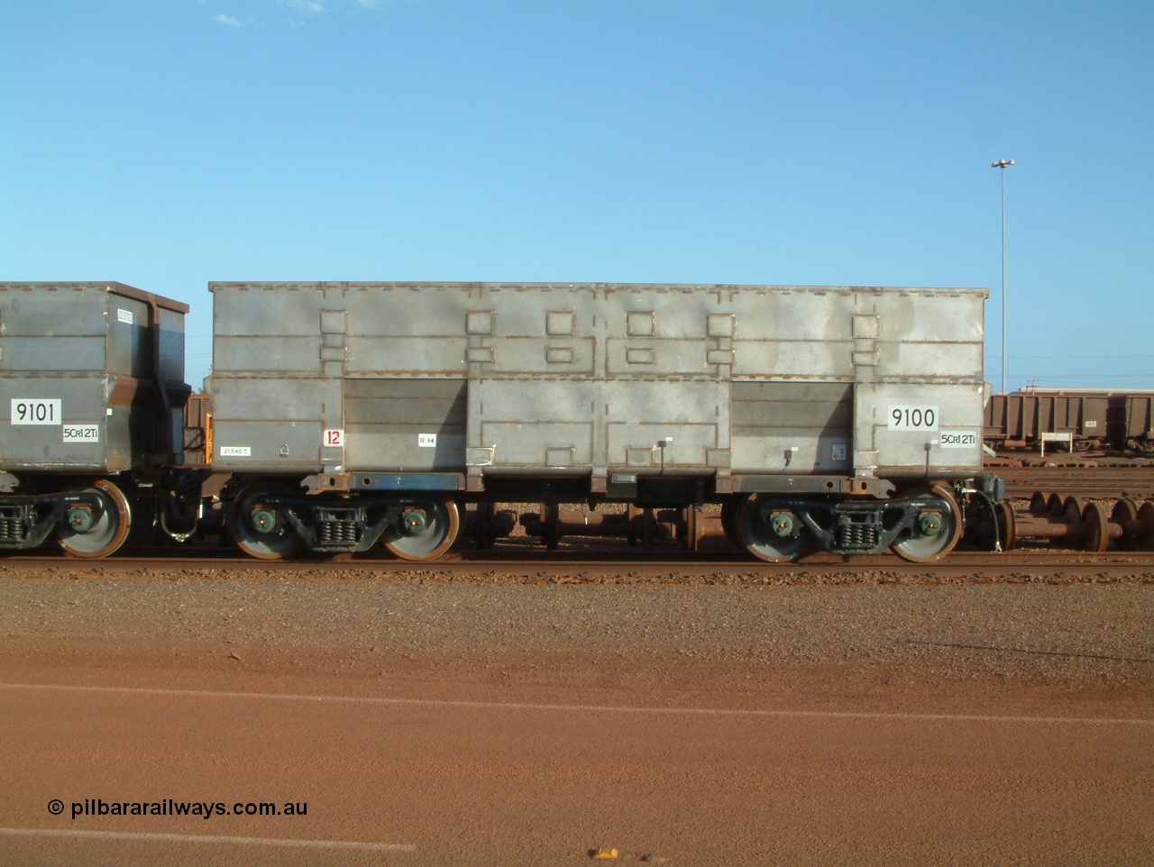 041225 064625
Nelson Point Ore Car Repair Shops, brand new Bradken NSW built ore waggon and type leader 9100 asset number 2031702. These waggons are the latest additions to the fleet with 20 on order in total. They are made from the same 5Cr12Ti steel that the Goninan Golynx waggons are made. 9100 has been set up for use as a 'test' waggon with load sensors located all over it. 25th December 2004.
Keywords: 9100;Bradken-NSW;BHP-ore-waggon;