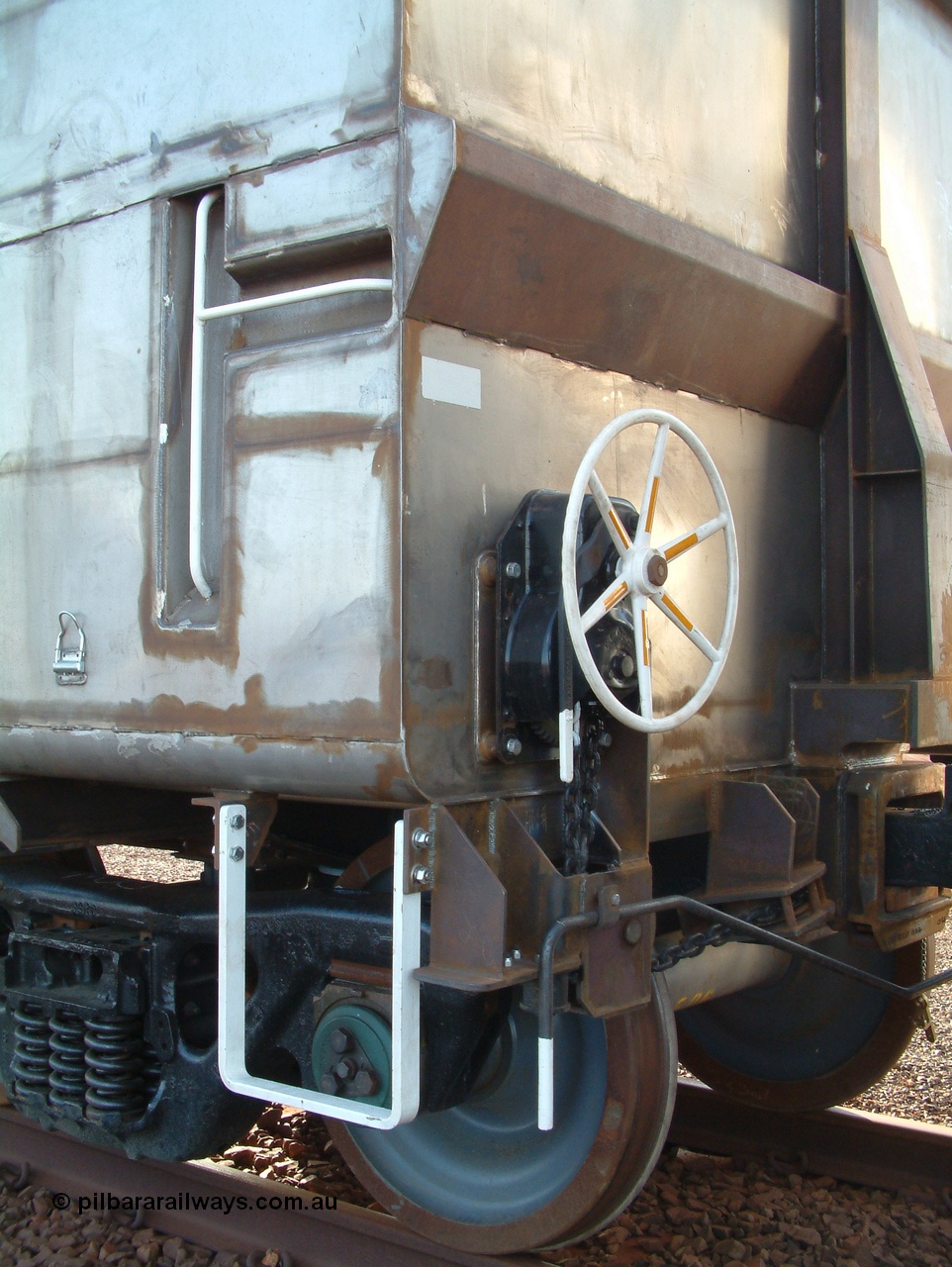 041225 065025
Nelson Point Ore Car Repair Shops, brand new Bradken NSW built ore waggon 9101 handbrake detail. These waggons are the latest additions to the fleet with 20 on order in total. They are made from the same 5Cr12Ti steel that the Goninan Golynx waggons are made. 25th December 2004.
Keywords: 9101;Bradken-NSW;BHP-ore-waggon;