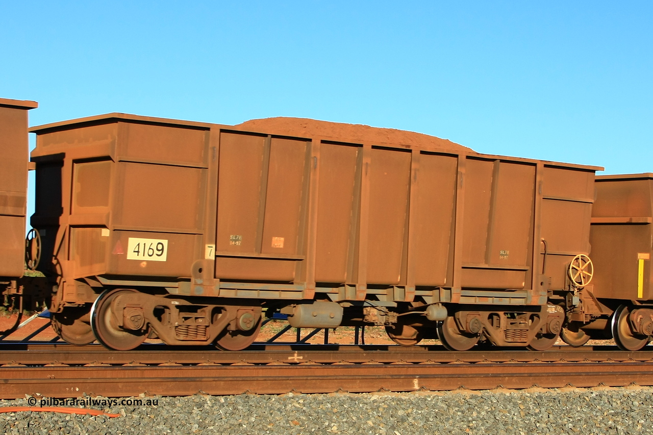 110620 2479r
Walla, loaded BHP ore waggon 4169 is a Goninan WA build from an order of one hundred and twenty-six waggons in 1997 with a tapered floor and rounded wall bottoms using 3CR12 stainless steel in an effort to eliminate internal painting and reducing wear on the waggon body, these were designated HC7081. 20th of June 2011.
Keywords: 4169;Goninan-WA;HC7081;BHP-ore-waggon;