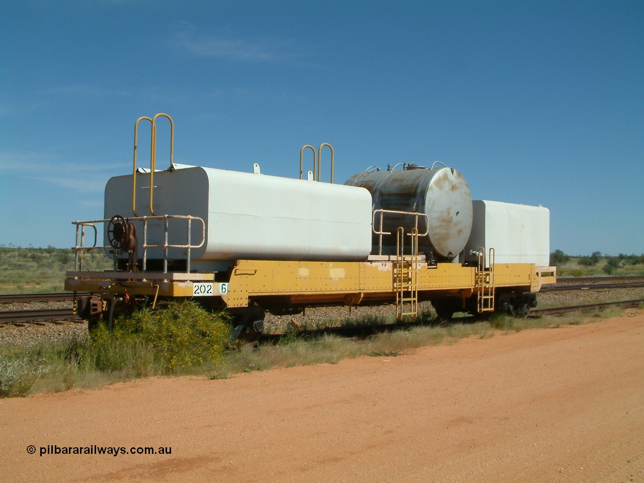 040419 102034
Abydos back track, riveted flat waggon 202 with three water tanks fitted, 3/4 view from handbrake end, originally part of the 'camp train', modified by Mt Newman Mining railway workshops.
Keywords: BHP-flat-waggon;