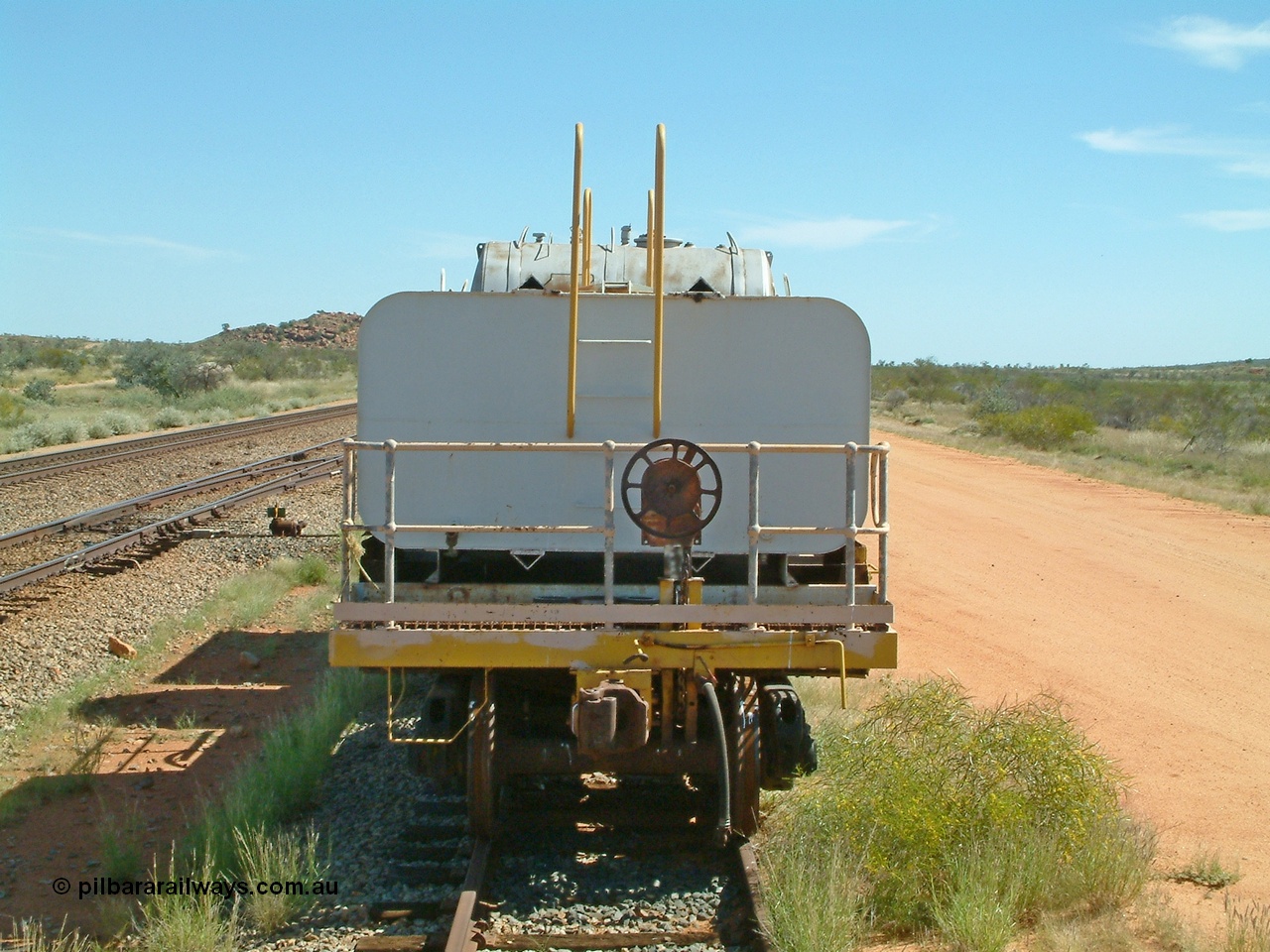 040419 102104
Abydos back track, riveted flat waggon 202 with three water tanks fitted, view of handbrake end, originally part of the 'camp train', modified by Mt Newman Mining railway workshops.
Keywords: BHP-flat-waggon;