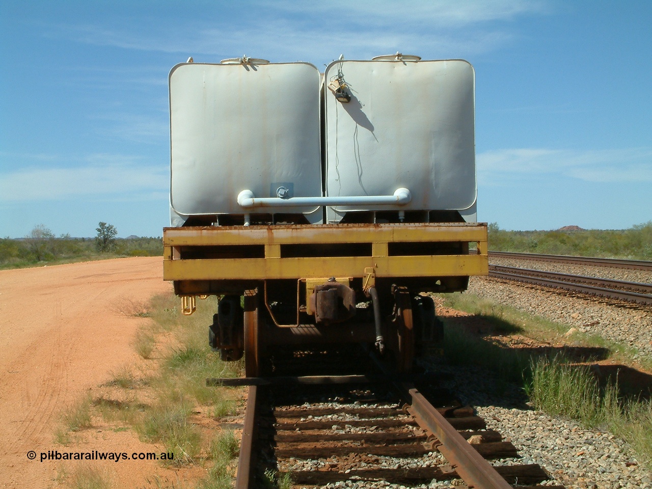040419 102145
Abydos back track, riveted flat waggon 202 with three water tanks fitted, view of non-handbrake end, originally part of the 'camp train', modified by Mt Newman Mining railway workshops.
Keywords: BHP-flat-waggon;