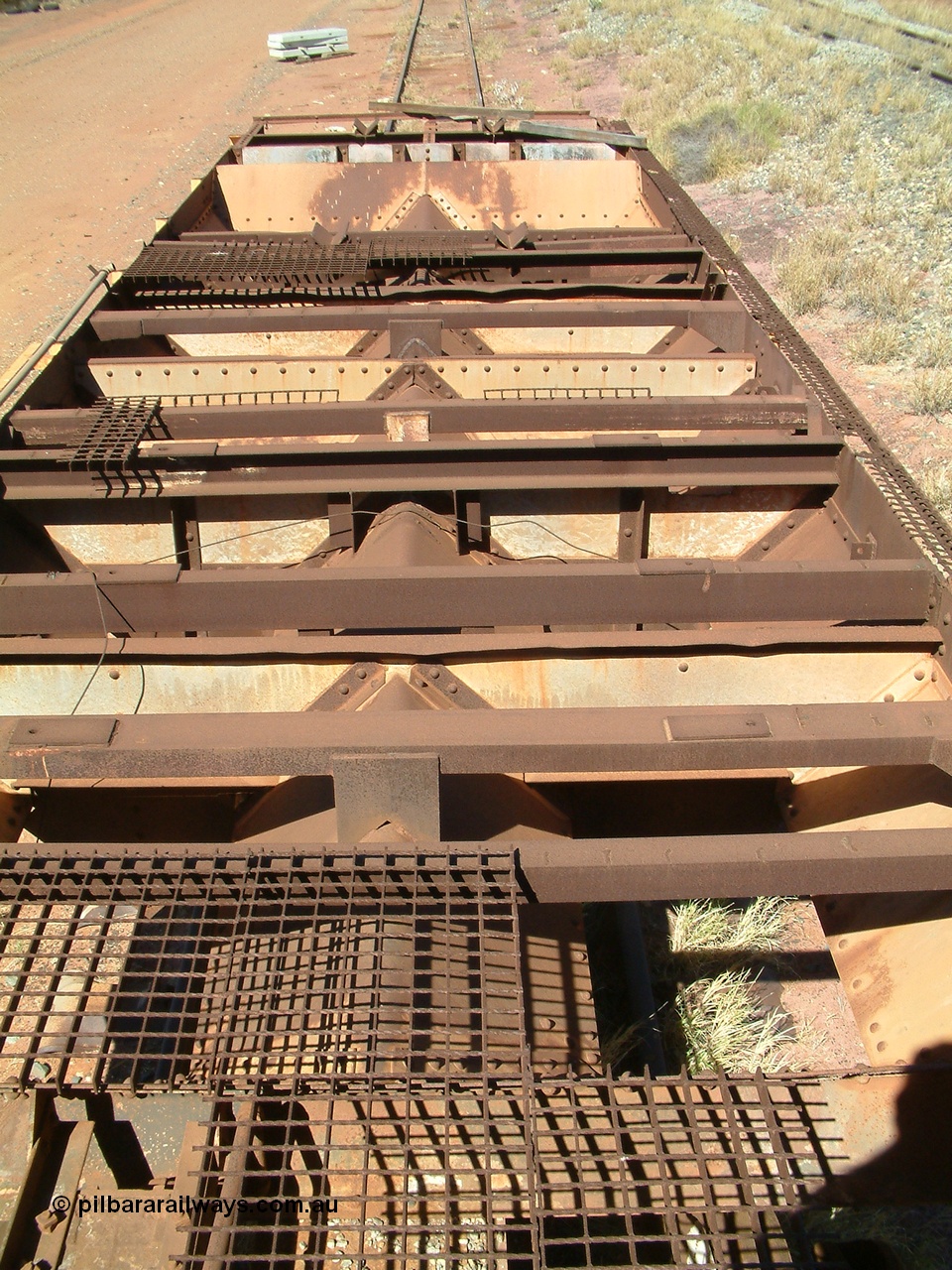 040806 102052
Flash Butt yard, heavily stripped down riveted waggon 206, possible original ballast waggon, number 206 was originally a waggon in the 'Camp Train' and appears to have USA origin, view of the removed deck showing chutes.
