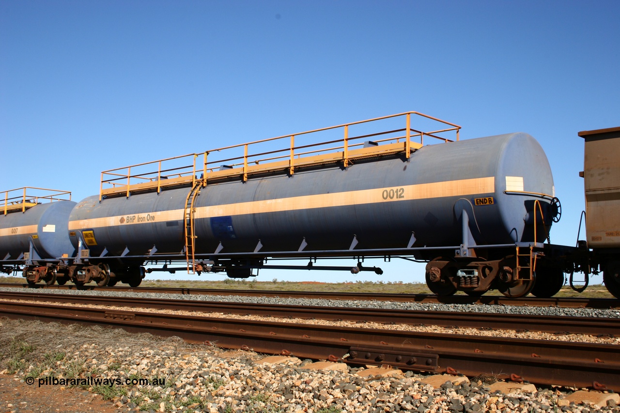 050704 3970
Bing Siding, empty 116 kL Comeng NSW built tank waggon 0012 from 1972, one of three such tank waggons, on the rear of a loaded ore train.
Keywords: Comeng-NSW;BHP-tank-waggon;