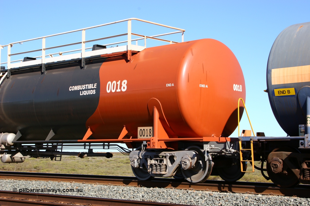 050704 3977
Bing Siding, empty 116 kL Comeng WA built tank waggon 0018 from 1974-5, one of six such tank waggons, detail of the A end and bogie, wearing the BHP Billiton Earth livery.
Keywords: Comeng-WA;BHP-tank-waggon;