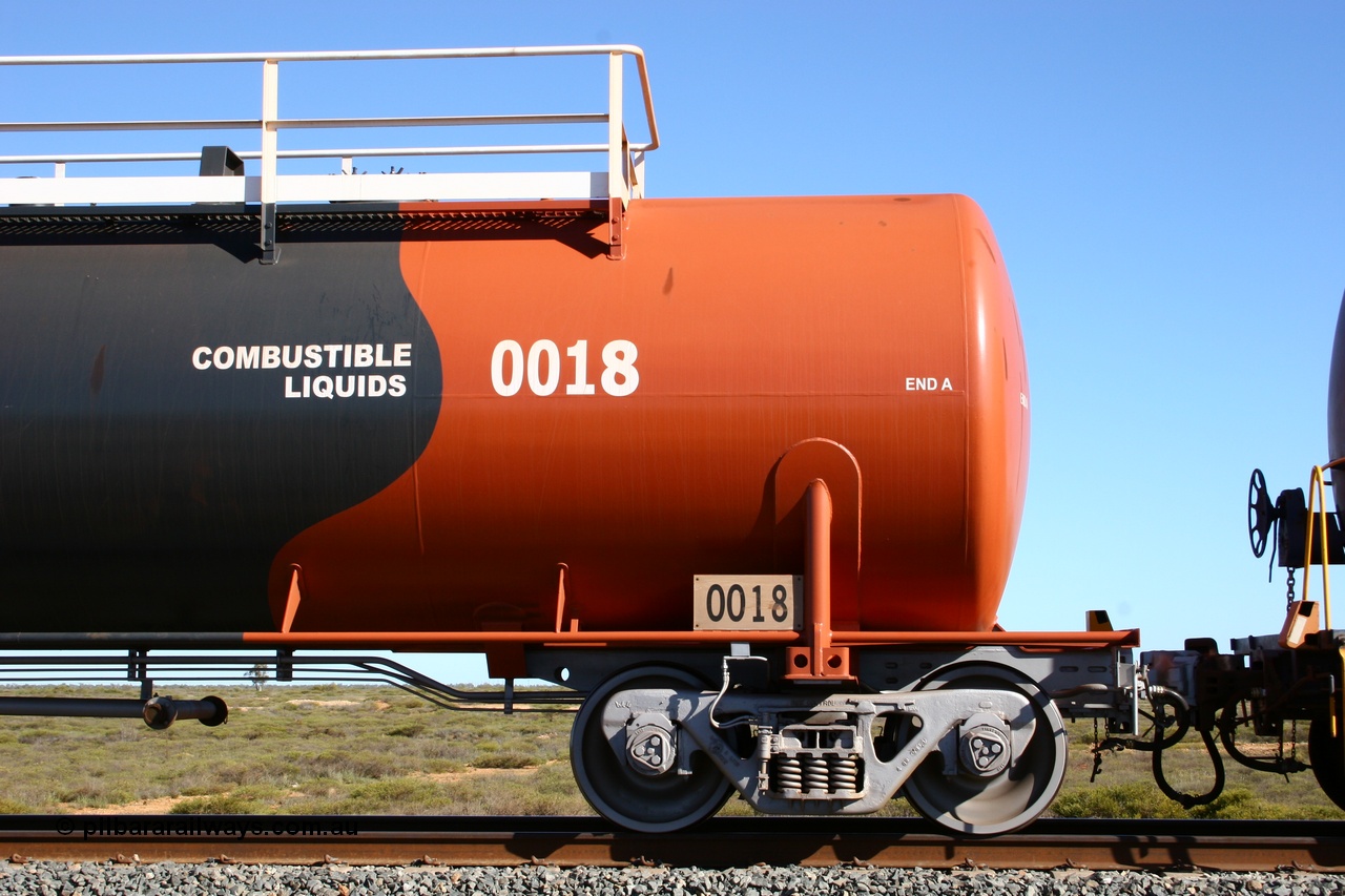 050704 3978
Bing Siding, empty 116 kL Comeng WA built tank waggon 0018 from 1974-5, one of six such tank waggons, detail of the A end and bogie, wearing the BHP Billiton Earth livery.
Keywords: Comeng-WA;BHP-tank-waggon;