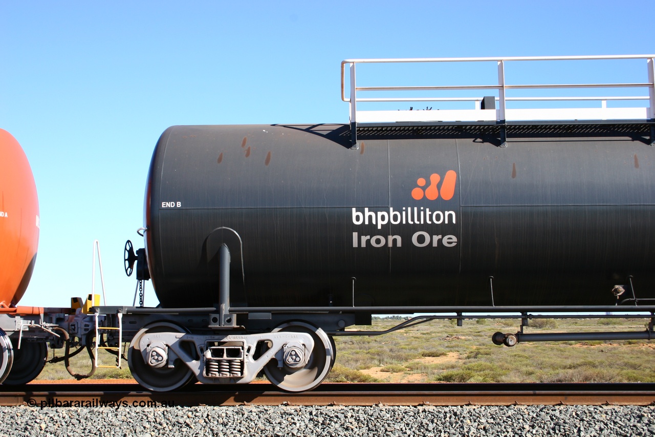 050704 3980
Bing Siding, empty 116 kL Comeng WA built tank waggon 0018 from 1974-5, one of six such tank waggons, detail of the B end and bogie, wearing the BHP Billiton Earth livery.
Keywords: Comeng-WA;BHP-tank-waggon;