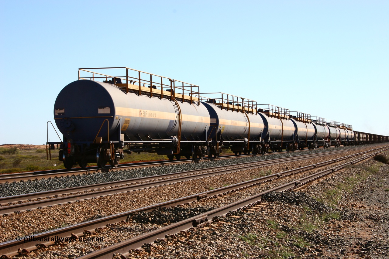 050704 3998
Bing Siding, empty 116 kL Comeng WA built tank waggon 0014 from 1974-5, one of six such tank waggons, empty tank waggons transported back to Port Hedland from Newman on the rear of loaded ore trains.
Keywords: Comeng-WA;BHP-tank-waggon;