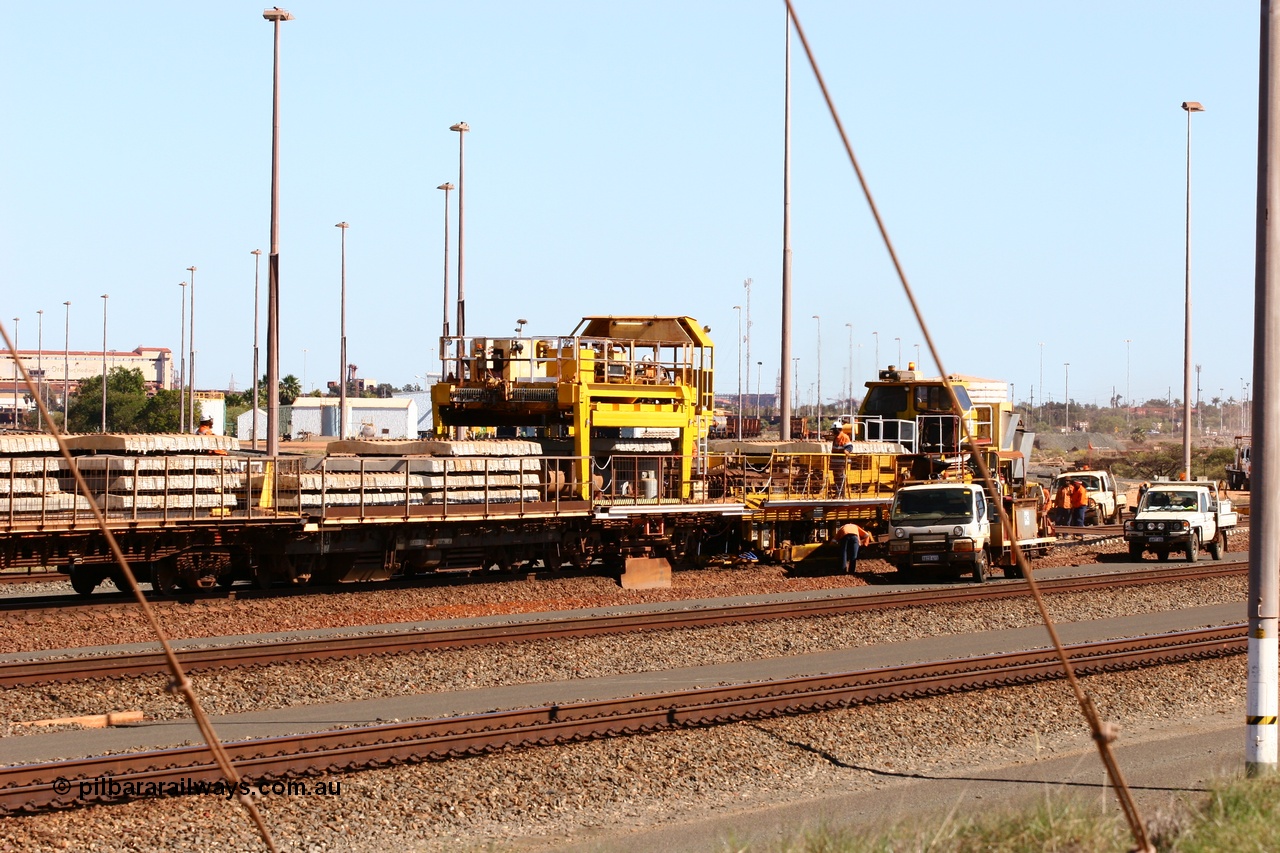 050724 4237
Nelson Point yard, flat waggons in service on the Pony re-laying train as transport waggons for sleepers, with a gantry car delivering concrete sleepers to replace the removed steel sleepers. The left waggon is an ex Goldsworthy Mining flat waggon with a Scotts of Ipswich built flat waggon with the gantry car on it, built in 1970 for then Mt Newman Mining Company.
Keywords: Scotts-Qld;BHP-pony-waggon;