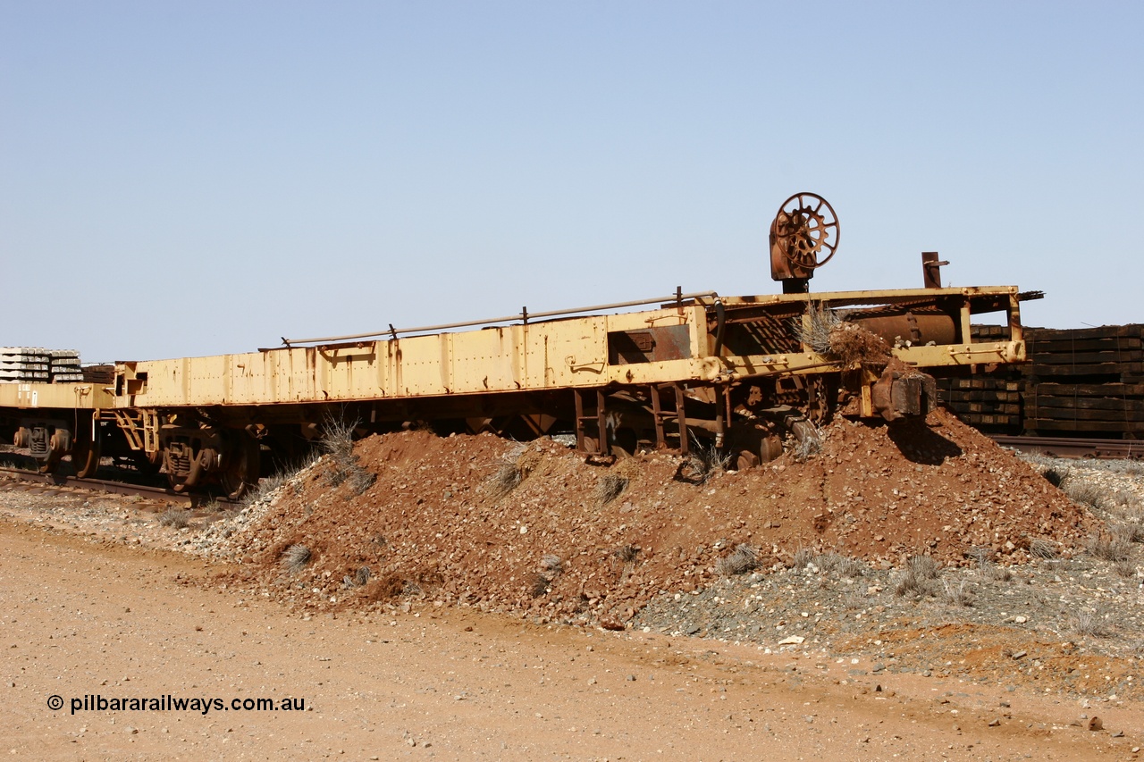 051001 5626
Flash Butt yard, heavily stripped down riveted waggon 206, possible original ballast waggon, number 206 was originally a waggon in the 'Camp Train' and appears to have USA origin, view of handbrake end, pushed into earth bund.
Keywords: BHP-flat-waggon;