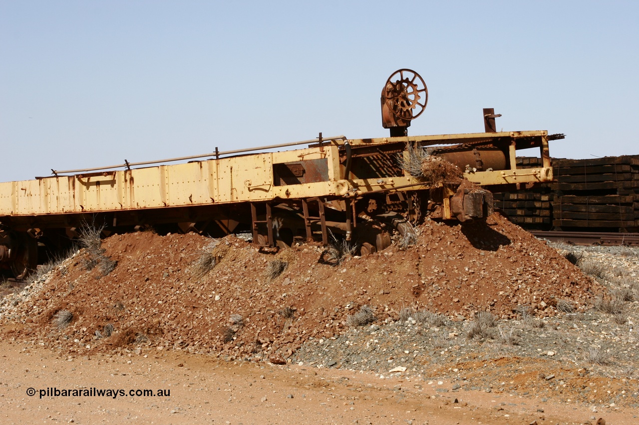 051001 5627
Flash Butt yard, heavily stripped down riveted waggon 206, possible original ballast waggon, number 206 was originally a waggon in the 'Camp Train' and appears to have USA origin, view of handbrake end, pushed into earth bund.
Keywords: BHP-flat-waggon;