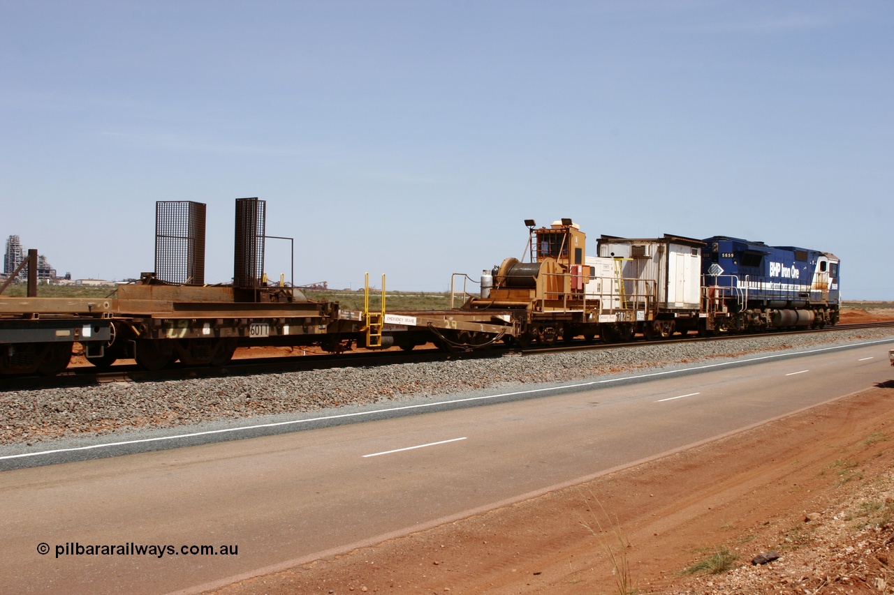 051001 5725
Boodarie, the Steel Train or rail recovery and transport train, 1st lead off waggon 6011, built by Scotts of Ipswich 04-09-1970, the mesh guarding is for the winch cable. The chute arrangement for the discharging and recovery of rail is visible. Then 6702 winch waggon and 665 the crib waggon.
Keywords: Scotts-Qld;BHP-rail-train;