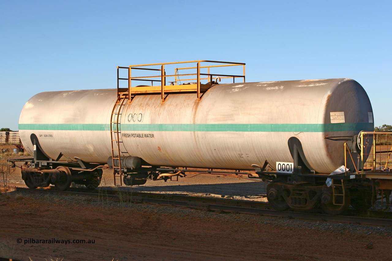 060429 3748
Flash Butt yard - South Hedland, water tank waggon 0001, originally built by Comeng NSW in November 1970 as one of two waggons with an 82,000 litre capacity. The other unit 0002 went on to become fuel tank 0020 after being converted to a weed spray waggon. 29th April 2006.
Keywords: Comeng-NSW;BHP-tank-waggon