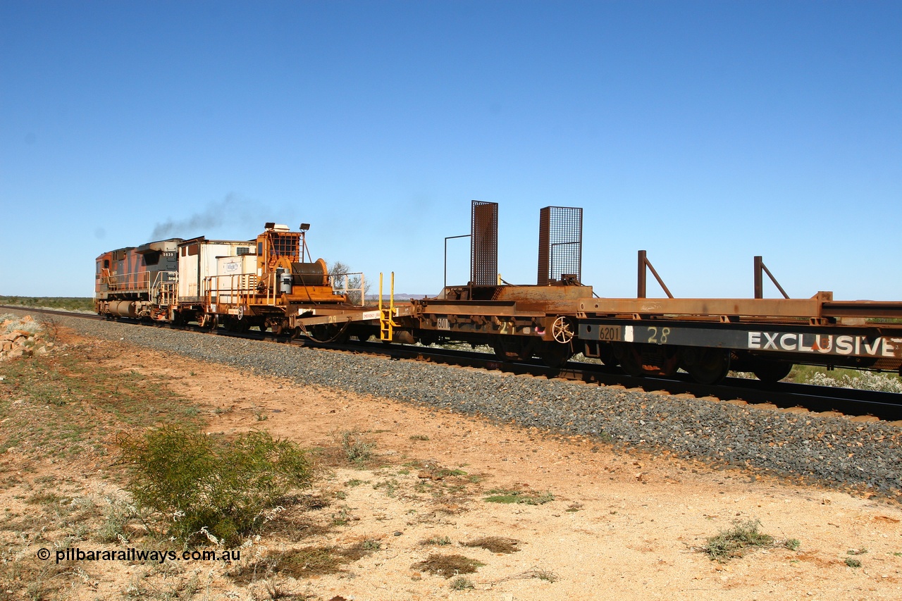 080621 2714
Tabba South, rail recovery and transport train, waggon #29, 1st lead off waggon 6011, built by Scotts of Ipswich Qld on 04-09-1970, the mesh guarding is for the winch cable. The chute arrangement for the discharging and recovery of rail is visible. In between 6702 and 6201.
Keywords: BHP-rail-train;Scotts-Qld;
