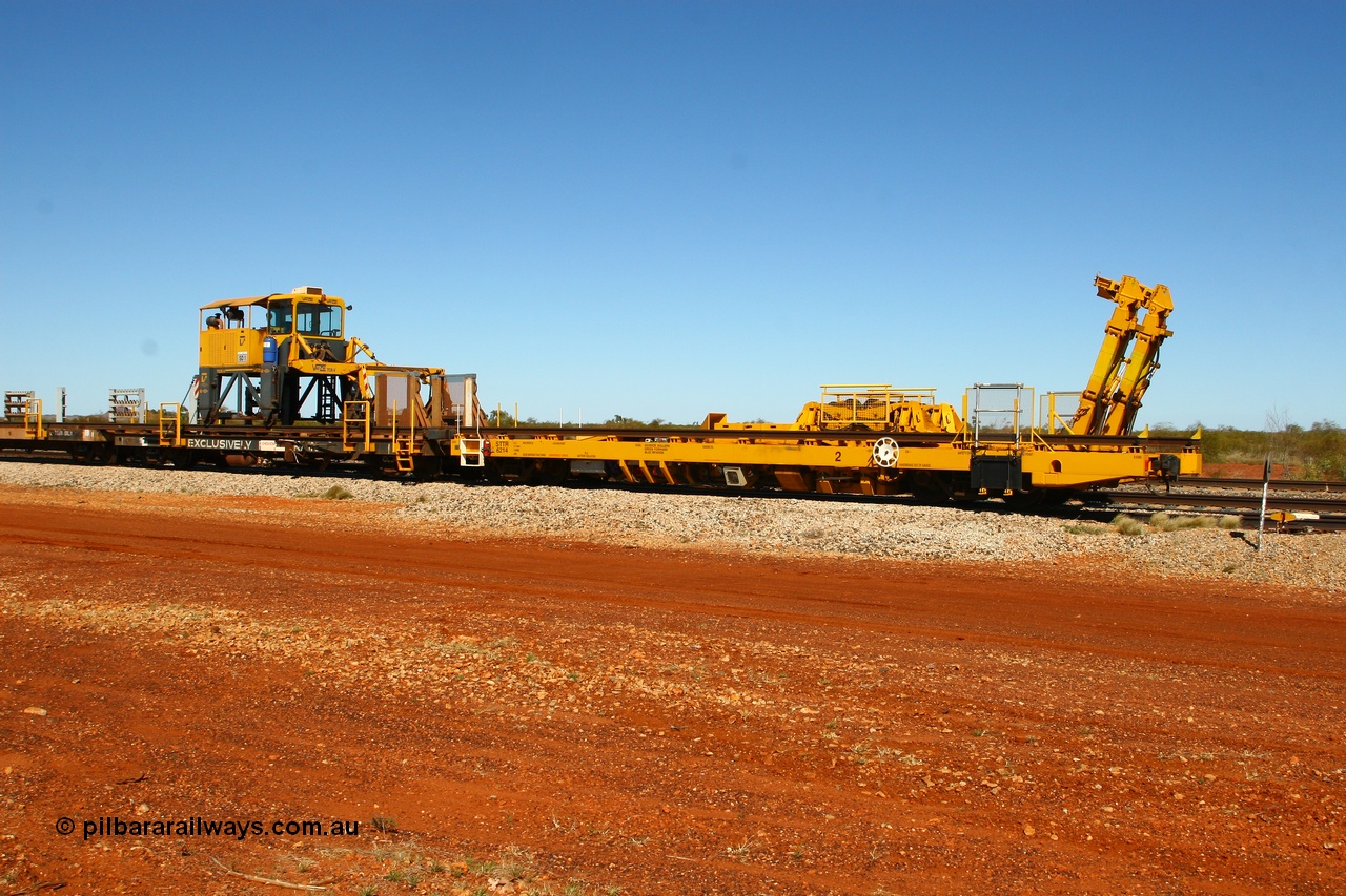 080621 2726
Gillman Siding, new Lead-Off Lead-On waggon STTR class STTR 6214 on the end of the Steel Train or rail recovery and transport train, built by Gemco Rail WA, the chutes can be seen standing up with the squeeze rollers behind the mesh with the original rear Lead-Off waggon 6203 and straddle crane.
Keywords: Gemco-Rail-WA;BHP-rail-train;STTR-type;STTR6214;