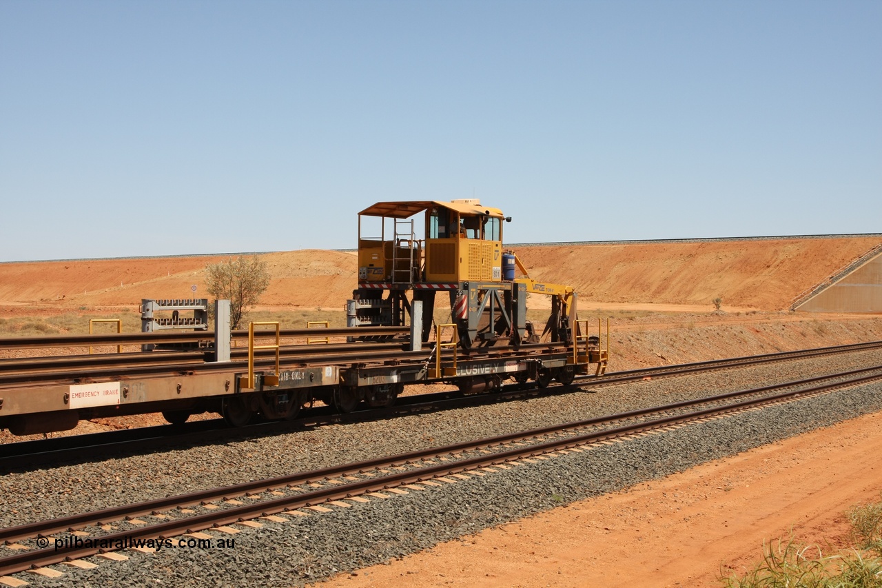 081217 0455
Woodstock Siding, rail recovery and transport train flat waggon #1, rear lead off waggon 6203, built by Comeng WA in January 1977 under order number 07-M-282 RY. The straddle crane is a newish unit built by Vaia Car model no. TCR-V and the four wheels are chain driven, replacing the original Gemco hydraulic unit.
Keywords: Comeng-WA;BHP-rail-train;