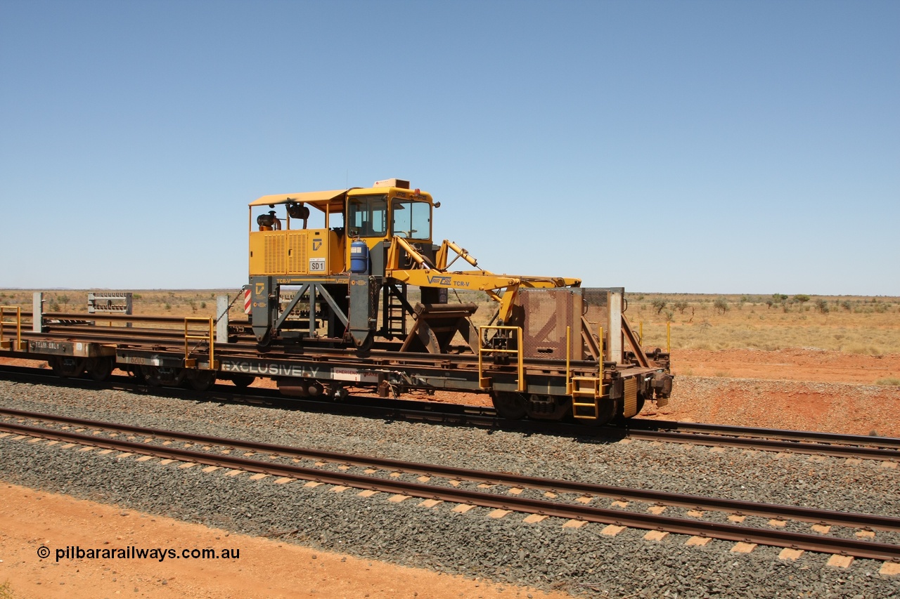 081217 0457
Woodstock Siding, rail recovery and transport train flat waggon #1, rear lead off waggon 6203, built by Comeng WA in January 1977 under order number 07-M-282 RY. The straddle crane is a newish unit built by Vaia Car model no. TCR-V and the four wheels are chain driven, replacing the original Gemco hydraulic unit.
Keywords: Comeng-WA;BHP-rail-train;