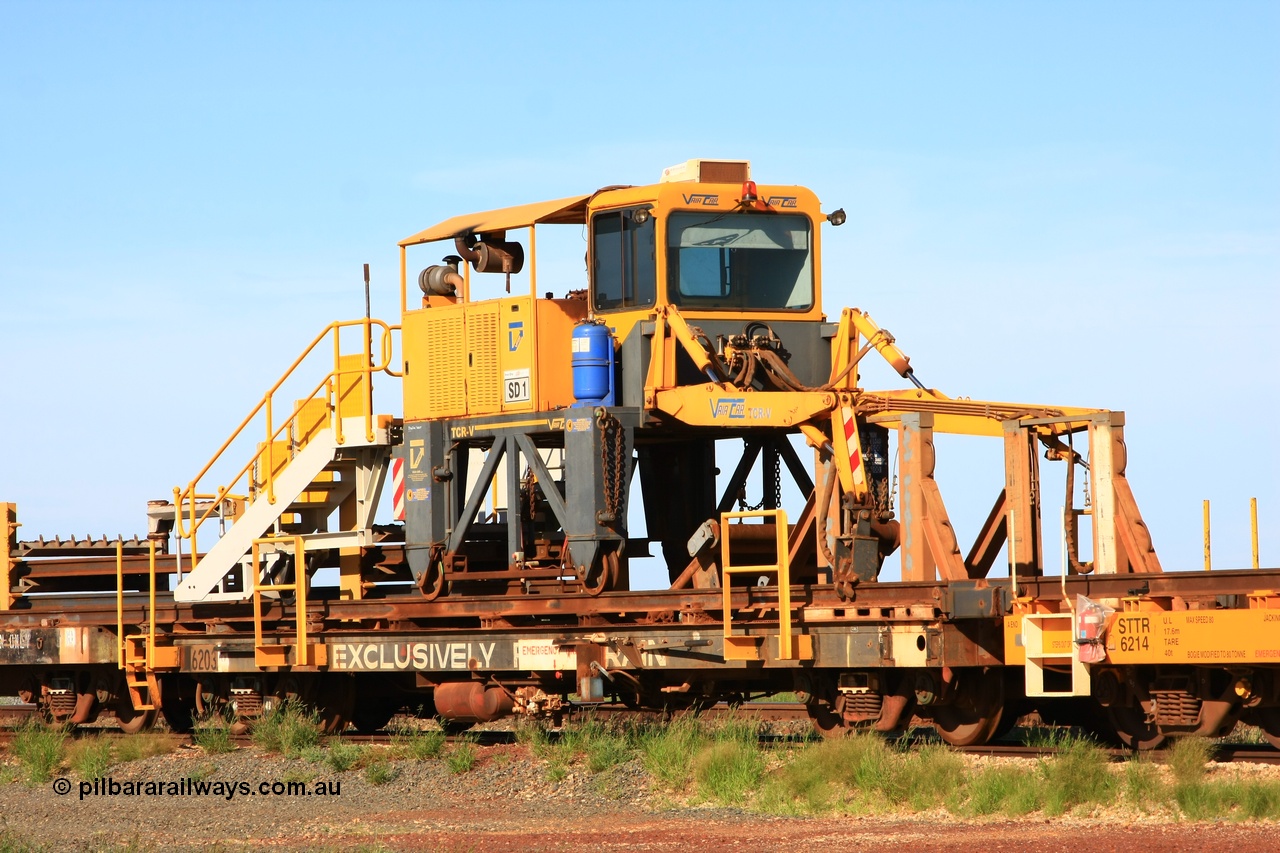 110208 9427
Flash Butt yard, rail recovery and transport train flat waggon rear lead off waggon 6203, built by Comeng WA in January 1977. The straddle crane is a newish unit built by Vaia Car model no. TCR-V and the four wheels are chain driven, replacing the original Gemco hydraulic unit.
Keywords: Comeng-WA;BHP-rail-train;