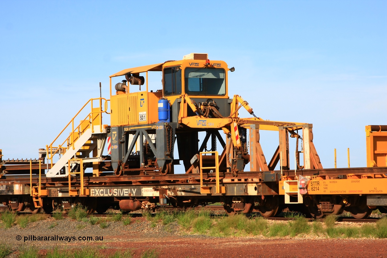 110208 9428
Flash Butt yard, rail recovery and transport train flat waggon rear lead off waggon 6203, built by Comeng WA in January 1977. The straddle crane is a newish unit built by Vaia Car model no. TCR-V and the four wheels are chain driven, replacing the original Gemco hydraulic unit.
Keywords: Comeng-WA;BHP-rail-train;