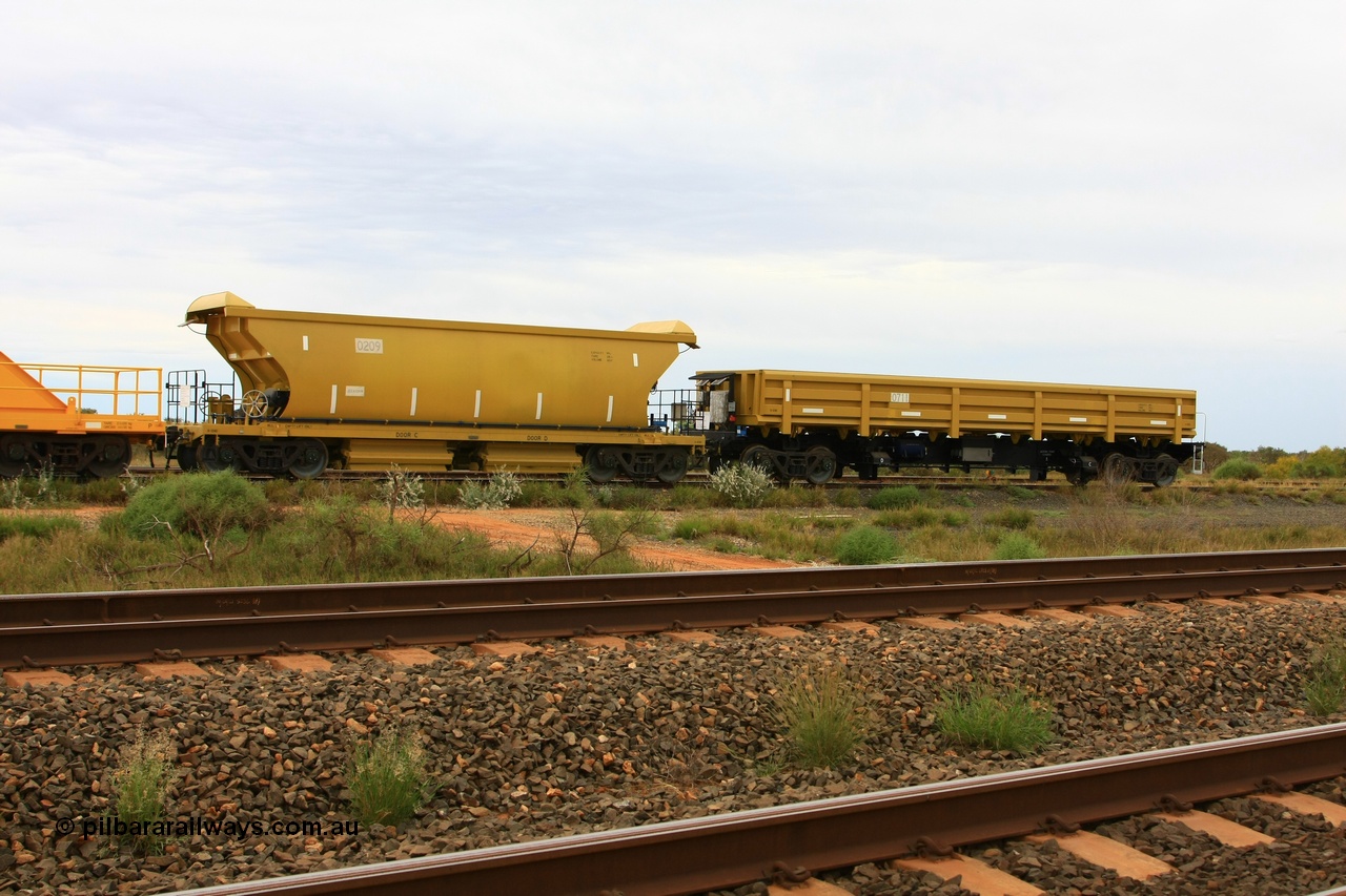 110606 1752
Flash Butt yard, CNR-QRRS of China built ballast waggons, 0209 is a 99 tonne bottom discharge and 0711 is an 80 tonne side dump waggon, both built and delivered in early 2011.
Keywords: CNR-QRRS-China;BHP-ballast-waggon;