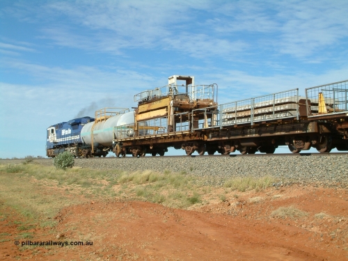 6703 Mt Newman Mining Workshops 040502 085548
Mooka Siding, trailing view of the 'Pony' heading south, 50 ton waggon 6703, one of three 'special' waggons converted from Magor USA built ore waggons, loaded with concrete sleepers is closet to camera. 
Keywords: Magor-USA;BHP-pony-waggon;