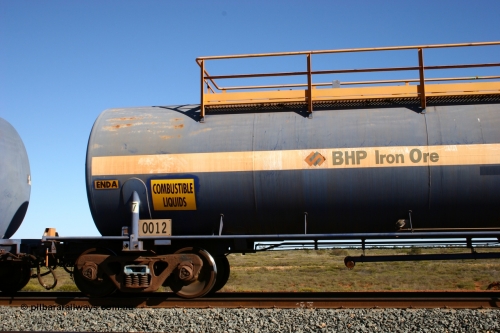 0012 Comeng NSW 050704 3974
Bing Siding, empty 116 kL Comeng NSW built tank waggon 0012 from 1972, one of three such tank waggons, view of A end and bogie detail.
Keywords: Comeng-NSW;BHP-tank-waggon;