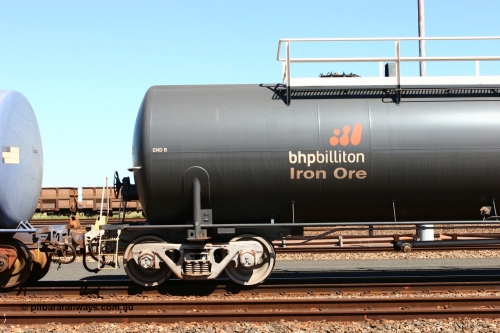 0015 Comeng WA 060414 3458
Nelson Point yard, empty fuel tank waggon 0015, view of B end and bogie, a Comeng WA built 116 kilolitre tank waggon, one of a batch of six built in 1974-75 wearing the newer corporate 'Earth' livery of BHP Billiton Iron Ore.
Keywords: Comeng-WA;BHP-tank-waggon;