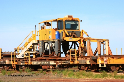 6203 Comeng WA 110208 9427
Flash Butt yard, rail recovery and transport train flat waggon rear lead off waggon 6203, built by Comeng WA in January 1977. The straddle crane is a newish unit built by Vaia Car model no. TCR-V and the four wheels are chain driven, replacing the original Gemco hydraulic unit.
Keywords: Comeng-WA;BHP-rail-train;