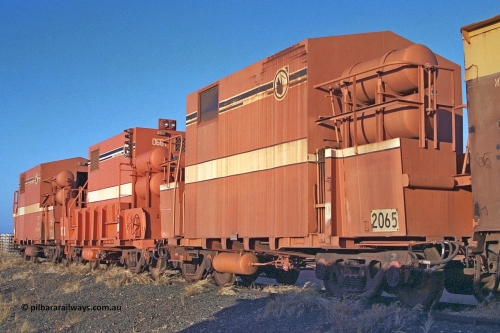 2065 Mt Newman Mining Workshops 257-14
Flash Butt yard, rear view of stored out of service LocoTrol waggons, 2065 closest to camera, then 661 and 2626. 2626 and 2065 converted from Comeng WA build ore waggons, 661 modified from a Magor USA Oroville build.
Keywords: Magor-USA;BHP-Locotrol-waggon;