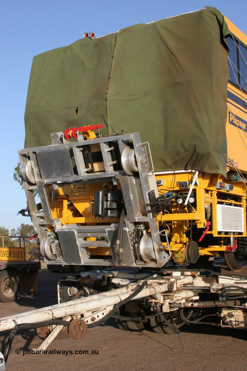 050409 0410
Shell Swagman Roadhouse, Lampson eighty wheel float ready to deliver BHP's new mainline tamper a Plasser Australia 09-3X model with serial M480 view of front trolley and tarp protecting windscreen. 9th April 2005.
Keywords: Tamper3;Plasser-Australia;09-3X;M480;track-machine;