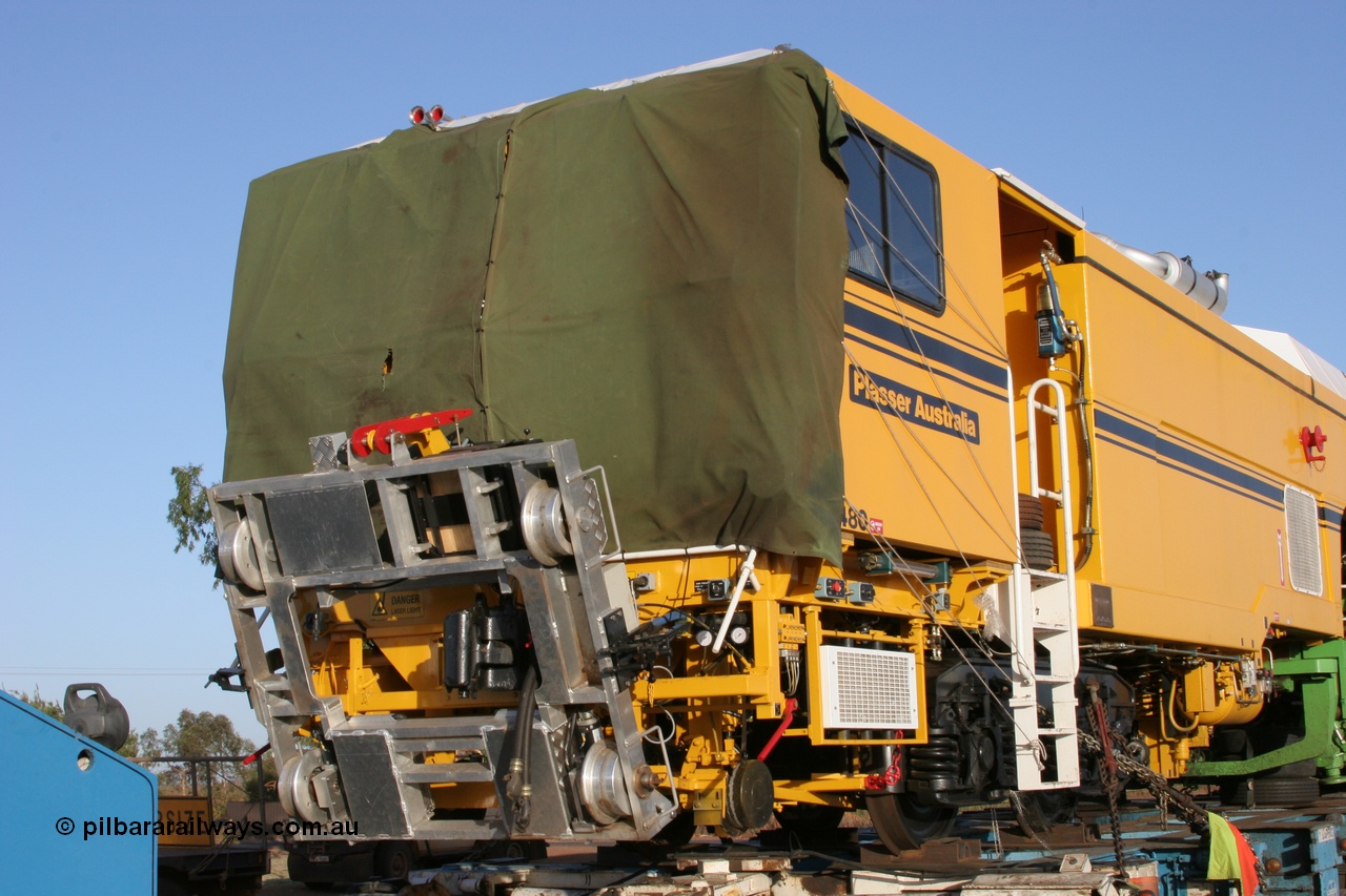 050409 0411
Shell Swagman Roadhouse, Lampson eighty wheel float ready to deliver BHP's new mainline tamper a Plasser Australia 09-3X model with serial M480 view of front trolley and tarp protecting windscreen. 9th April 2005.
Keywords: Tamper3;Plasser-Australia;09-3X;M480;track-machine;