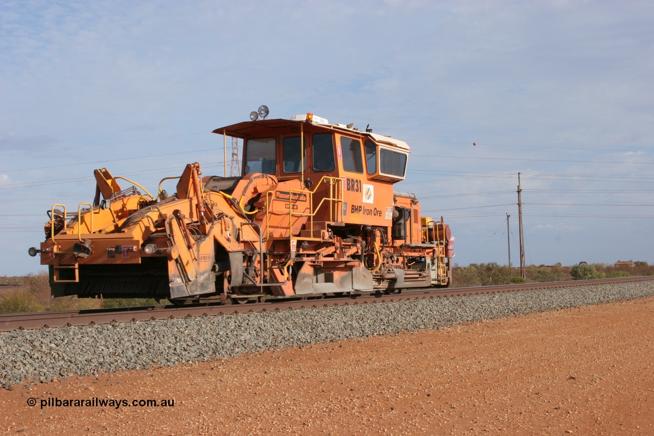 050411 0611
Goldsworthy Junction, BHP track machine ballast regulator BR 31 a Plasser Australia SSP 110SW model with serial 401 runs along the Newman mainline towards Bing Siding. 11th April 2005.
Keywords: BR31;Plasser-Australia;SSP-110SW;401;track-machine;