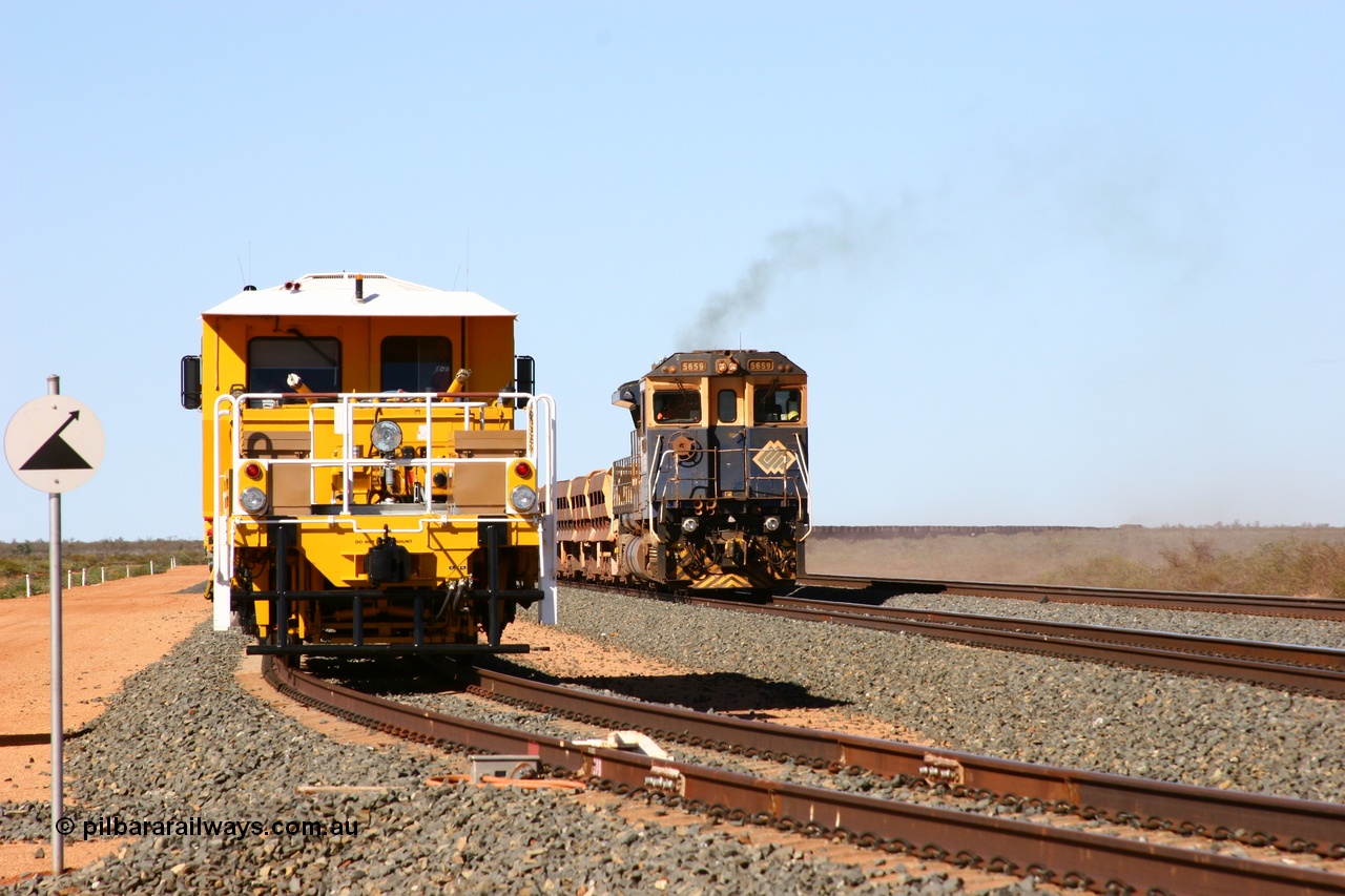 050625 3633
Mooka North backtrack holds BHP's new Tamper 3 track machine a Plasser Australia 09-3X model serial M480 as a ballast train runs past on the passing track as an empty ore train is on the mainline. 25th June 2005.
Keywords: Tamper3;Plasser-Australia;09-3X;M480;track-machine;