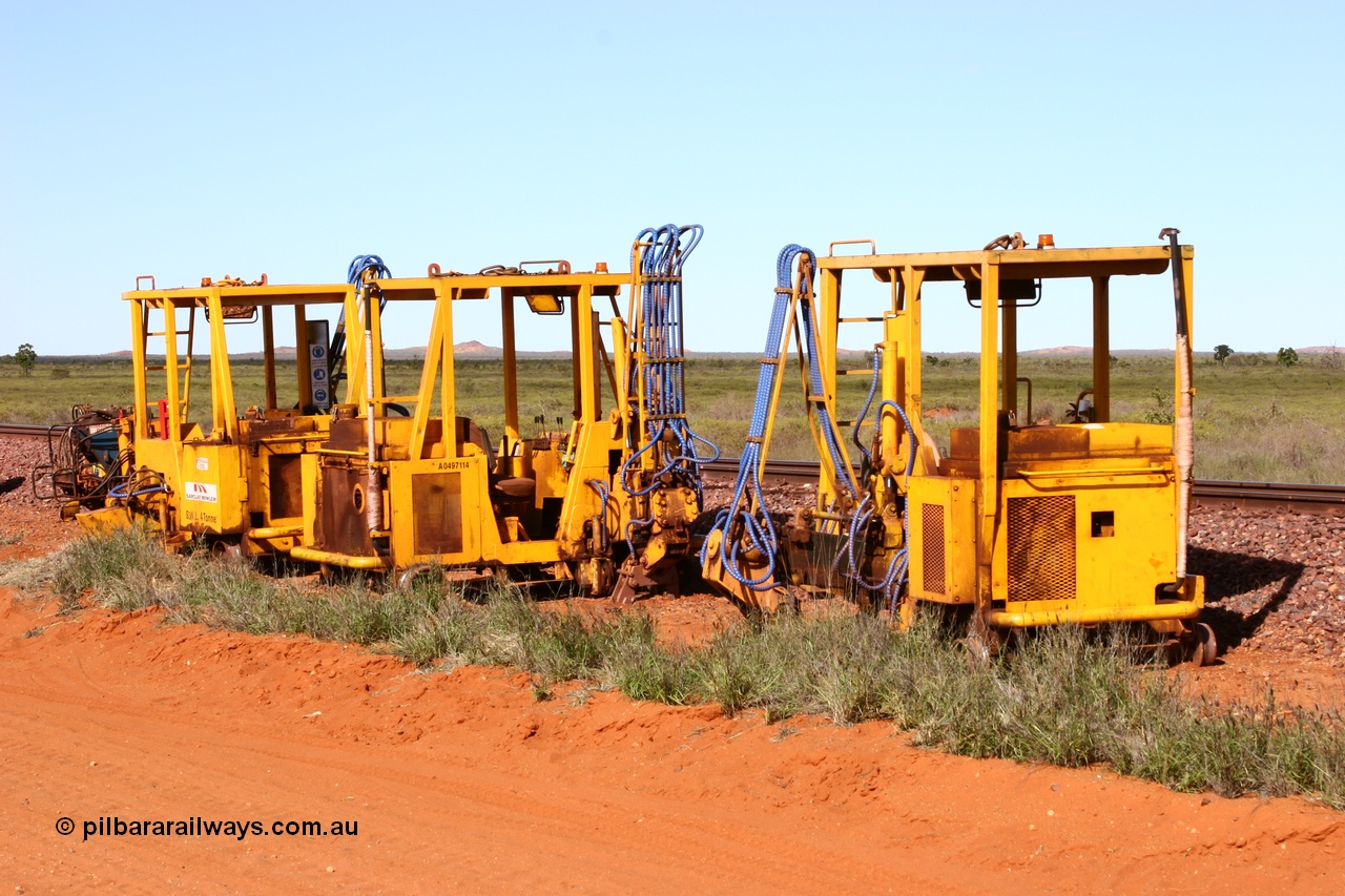 050625 3813
Node 2 at the 38 km on the GML or former Goldsworthy mainline, three Barclay Mowlem sleeper inserter track machines off clear of the running lines. 25th June 2005.
Keywords: track-machine;